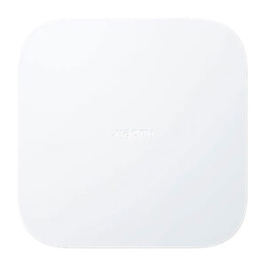 A sleek white Xiaomi Mi Smart Home Hub 2 device placed on a modern wooden table.